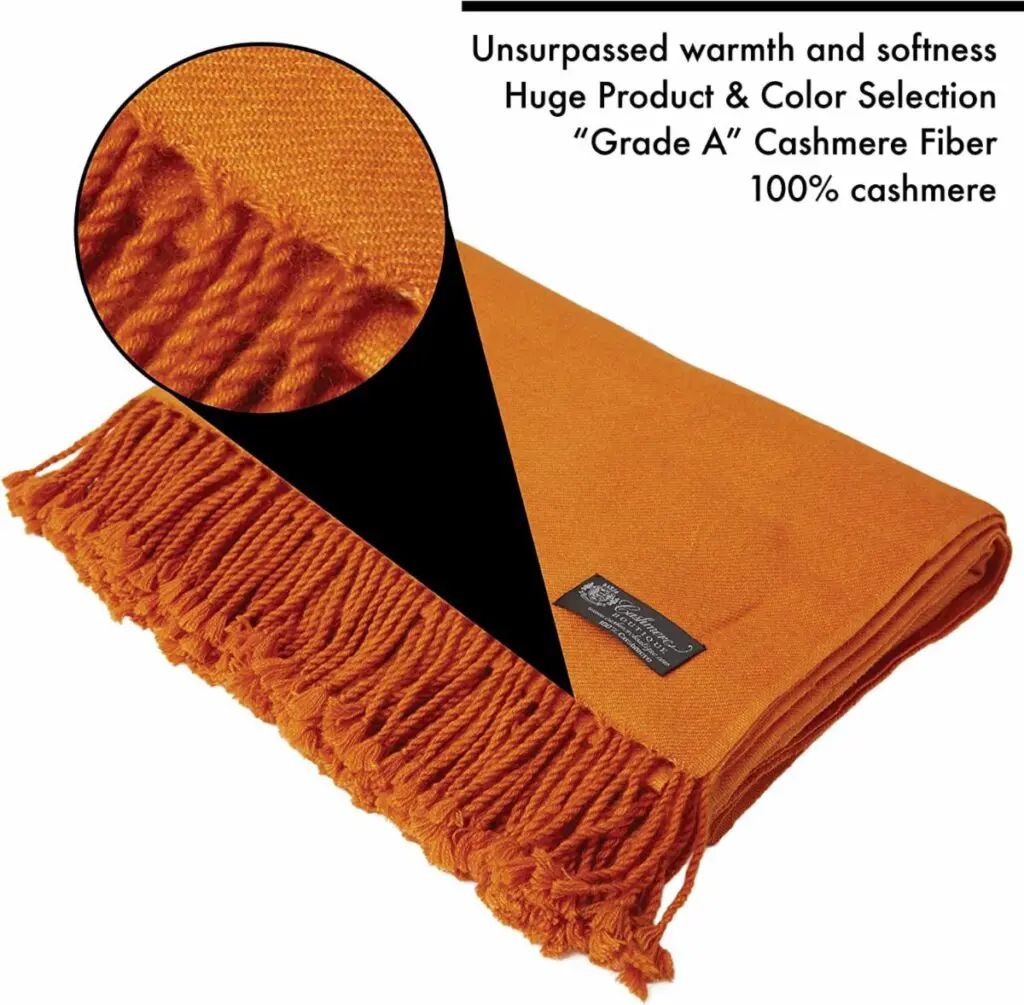 A close up of the orange blanket with a black label