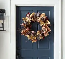 A blue door with a wreath on the front of it.