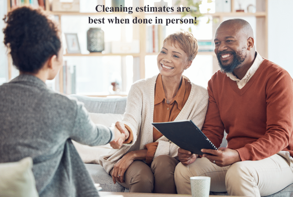 a picture of a couple sitting together in a home shaking on an agreement for house cleaning