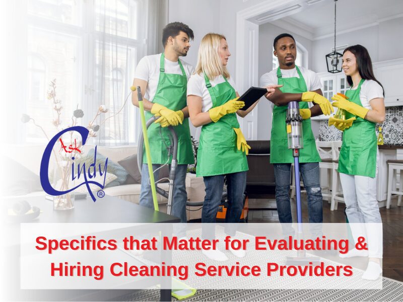 A team of cleaners stand in matching green aprons holding cleaning supplies with caption, “Specifics that matter for Evaluation & Hiring Cleaning Service Providers”