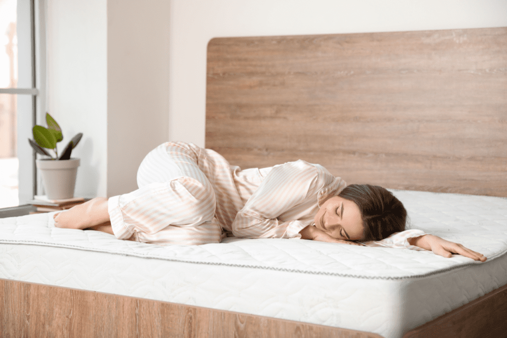 woman in her pajamas enjoying a fresh and clean new mattress