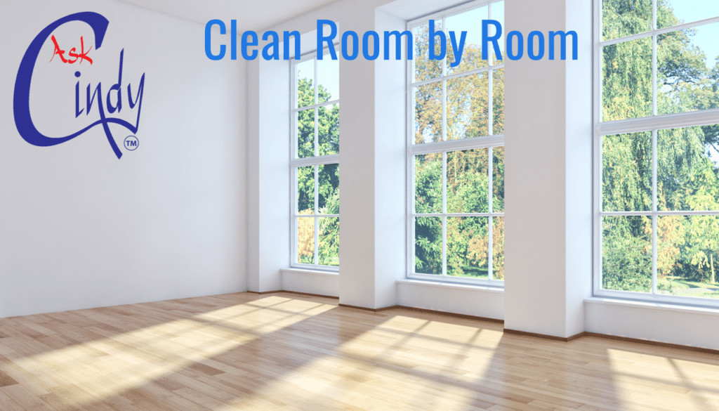 A clean room with two windows and trees in the background.