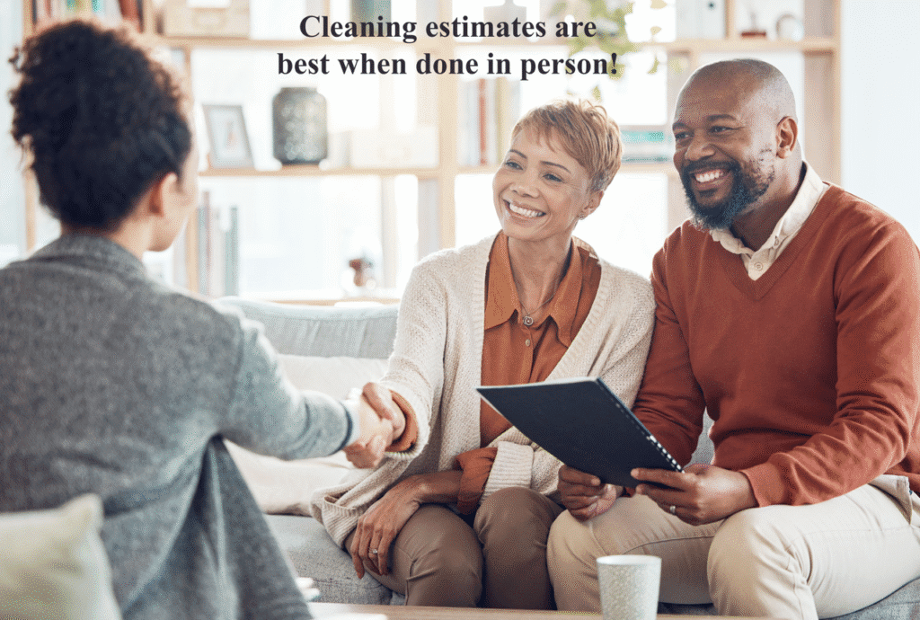 a picture of a couple sitting together in a home shaking on an agreement for house cleaning